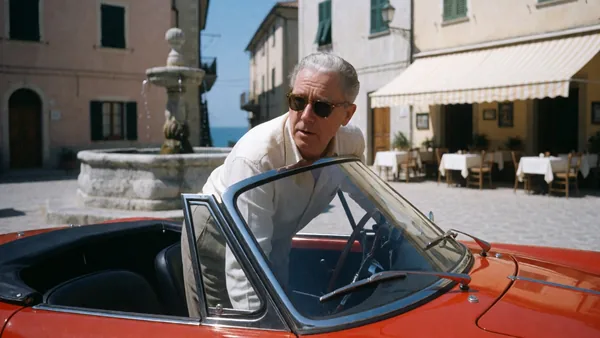 Still: two men embracing outside an Italian cafe