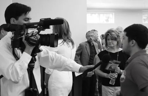 TV reporter on location with a microphone.
